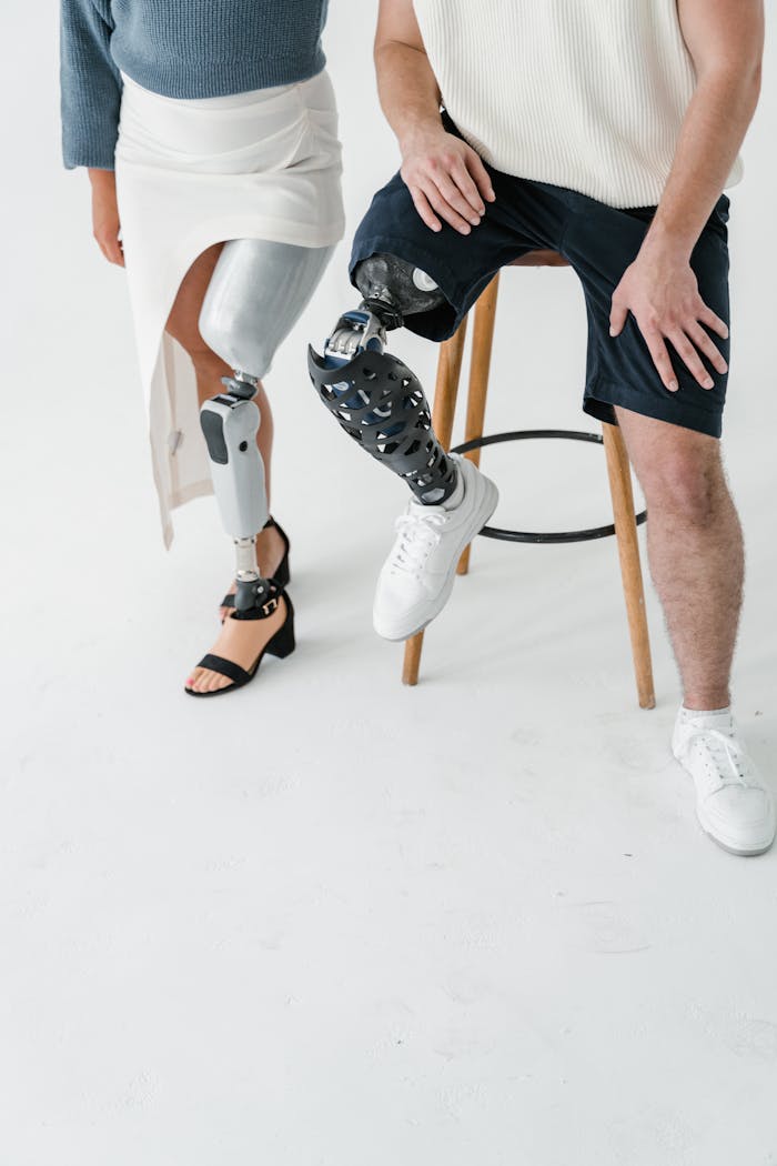 Services Two adults with prosthetic legs captured in a studio setting, highlighting technology and diversity.